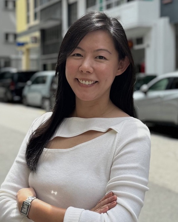 Jane, Head of Marketing, smiling with arms folded
